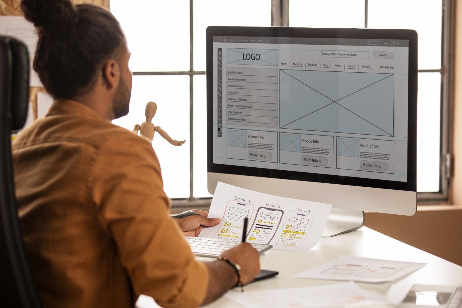 Web developer working with wireframes and website mockups